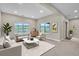 Bright living room with large windows offering scenic views, neutral furniture, and recessed lighting at 9754 W Ontario Pl, Littleton, CO 80128