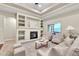 Cozy living room with a fireplace, built-in shelves, and views of the outdoors at 9754 W Ontario Pl, Littleton, CO 80128