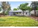 Backyard view featuring a well-maintained lawn and a patio area at 3065 S Eudora St, Denver, CO 80222