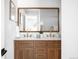Bathroom featuring a double vanity with marble countertop and a wood-framed mirror at 3065 S Eudora St, Denver, CO 80222