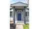 Inviting front porch with a stylish blue door and contemporary lighting fixtures at 3065 S Eudora St, Denver, CO 80222