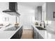 Well-lit kitchen featuring gray cabinets, white countertops, and stainless steel appliances at 3065 S Eudora St, Denver, CO 80222
