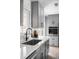 Contemporary kitchen with gray cabinets, quartz counters, and stainless steel appliances at 3065 S Eudora St, Denver, CO 80222