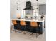 Bright kitchen features a large island with modern appliances and stylish bar stools at 3065 S Eudora St, Denver, CO 80222