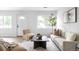 Inviting living room featuring a cream sofa, a modern rug, and natural light at 3065 S Eudora St, Denver, CO 80222