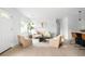 Bright living room with wood floors, neutral tones, and comfortable seating arrangement at 3065 S Eudora St, Denver, CO 80222