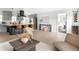 Open-concept living room with modern gray kitchen, counter seating, and stylish decor at 3065 S Eudora St, Denver, CO 80222