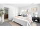 Cozy bedroom with plush bedding, a neutral rug, ensuite bath, and a sun-filled window at 3065 S Eudora St, Denver, CO 80222
