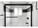 Modern bathroom shower with sleek black hardware, white subway tile, and a window at 3065 S Eudora St, Denver, CO 80222