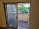 View from the balcony showcasing a leafy tree and neighborhood, accessible through sliding glass doors at 10211 Ura Ln # 9-308, Thornton, CO 80260