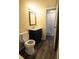 Cozy bathroom features a blue vanity, framed mirror, and a separate water closet at 10211 Ura Ln # 9-308, Thornton, CO 80260