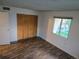 Bedroom with ample storage with a spacious closet, and wood-look floors at 10211 Ura Ln # 9-308, Thornton, CO 80260