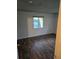 Bedroom featuring wood-look flooring, a large window, and bright natural light at 10211 Ura Ln # 9-308, Thornton, CO 80260
