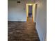 Open living space with attractive wood-look floors and a view into adjacent rooms at 10211 Ura Ln # 9-308, Thornton, CO 80260