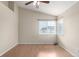Bedroom featuring wood-look flooring, two windows, and a ceiling fan at 19240 E Carolina Dr # 104, Aurora, CO 80017