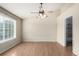 Spacious bedroom featuring a ceiling fan, large window, and vinyl wood flooring at 19240 E Carolina Dr # 104, Aurora, CO 80017