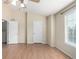Bright bedroom with a ceiling fan, wood-look floors, and large window at 19240 E Carolina Dr # 104, Aurora, CO 80017