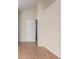 Bedroom with wood-look floors and a white door with brass hardware at 19240 E Carolina Dr # 104, Aurora, CO 80017