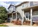 Townhome exterior featuring a covered porch and mature landscaping at 19240 E Carolina Dr # 104, Aurora, CO 80017