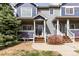 Charming townhome with well-maintained landscaping, inviting entryway and partial view of mature evergreen tree at 19240 E Carolina Dr # 104, Aurora, CO 80017