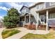 Inviting townhome exterior with manicured lawn, walkway and mature landscaping at 19240 E Carolina Dr # 104, Aurora, CO 80017
