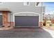 Single-car garage with gray door, brick accents, and unit number at 19240 E Carolina Dr # 104, Aurora, CO 80017