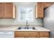 Well-lit kitchen featuring a stainless steel sink, modern appliances, and wooden cabinets at 19240 E Carolina Dr # 104, Aurora, CO 80017