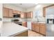 Well-lit kitchen featuring stainless steel appliances, ample counter space and wood cabinets at 19240 E Carolina Dr # 104, Aurora, CO 80017
