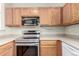 Close-up of modern kitchen appliances and wooden cabinets at 19240 E Carolina Dr # 104, Aurora, CO 80017