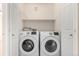 Convenient laundry room with modern Samsung washer and dryer units and built-in shelving at 19240 E Carolina Dr # 104, Aurora, CO 80017