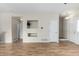 Spacious living room featuring hardwood floors with built in shelves at 19240 E Carolina Dr # 104, Aurora, CO 80017