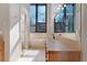 A spacious bathroom featuring ample natural light, large mirrors, and a walk-in shower at 160 N Fuller Placer Rd, Breckenridge, CO 80424