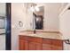 Bathroom vanity featuring neutral walls, a mirror, granite counters, and a dark wood door frame at 160 N Fuller Placer Rd, Breckenridge, CO 80424