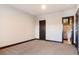 Bedroom featuring neutral carpet, neutral walls, and a dark wood door frame leading to another room at 160 N Fuller Placer Rd, Breckenridge, CO 80424