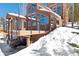 Exterior shot of home featuring many windows, with snow covering the ground at 160 N Fuller Placer Rd, Breckenridge, CO 80424