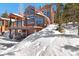 View of house with lots of windows and snow on the ground at 160 N Fuller Placer Rd, Breckenridge, CO 80424