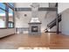 Bright living room with stone fireplace, wood floors, and staircase to upper level at 160 N Fuller Placer Rd, Breckenridge, CO 80424