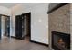 Living room featuring a stone fireplace, hardwood floors, and dark wood door frames leading to other rooms at 160 N Fuller Placer Rd, Breckenridge, CO 80424