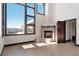 Living room with stone fireplace and expansive windows showcasing mountain views at 160 N Fuller Placer Rd, Breckenridge, CO 80424