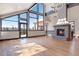 Bright living room boasts high ceilings, a fireplace, and large windows for stunning views at 160 N Fuller Placer Rd, Breckenridge, CO 80424