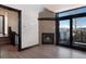 Living room featuring a stone fireplace, hardwood floors, and a sliding glass door with mountain views at 160 N Fuller Placer Rd, Breckenridge, CO 80424