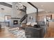 Elegant living room with stone fireplace, staircase and ample natural light at 160 N Fuller Placer Rd, Breckenridge, CO 80424