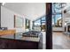 Bright living room with wood floors, stone fireplace, and expansive windows showcasing mountain views at 160 N Fuller Placer Rd, Breckenridge, CO 80424