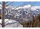 Mountain view with ski runs as seen through the trees at 160 N Fuller Placer Rd, Breckenridge, CO 80424