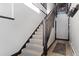 Carpeted staircase with wood railing leading to the upper level of the home at 160 N Fuller Placer Rd, Breckenridge, CO 80424