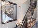 Elegant staircase with wood railing and unique pendant lighting fixture at 160 N Fuller Placer Rd, Breckenridge, CO 80424