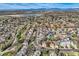 Expansive aerial view showcases the neighborhood, nearby lake, and the stunning snow-capped mountain range in the distance at 3803 Dyanna Dr, Thornton, CO 80241