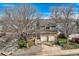 Charming two-story home with brick accents and an attached two-car garage, framed by mature trees at 3803 Dyanna Dr, Thornton, CO 80241