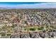 Wide aerial view highlights the community with tree-lined streets, green spaces, and beautiful blue sky at 3803 Dyanna Dr, Thornton, CO 80241