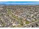 This aerial view displays a well-planned community with easy access to roadways and a majestic mountain backdrop at 3803 Dyanna Dr, Thornton, CO 80241